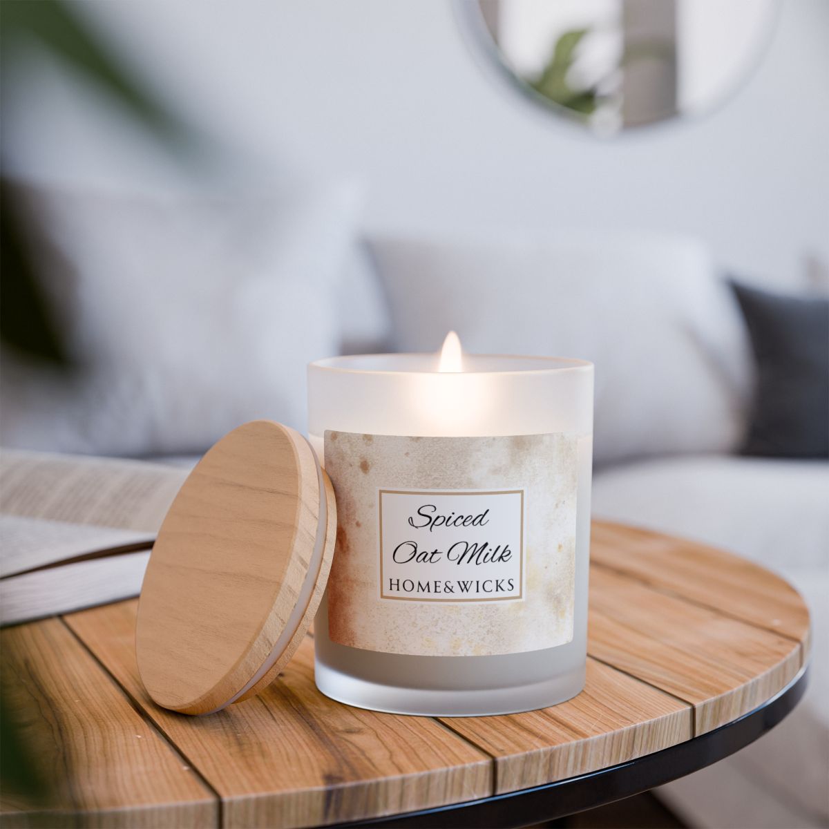 Candle labeled 'Spiced Oat Milk' from HOME & WICKS on a wooden table with a blurred background