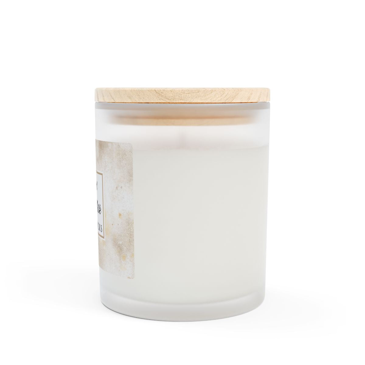 Side View of spiced oat milk white frosted candle jar with a wooden lid on a white background