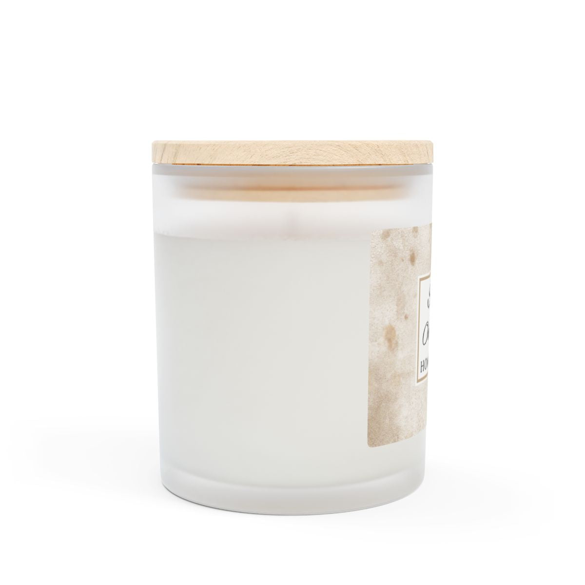 Side view of spiced oat milk white frosted candle with a wooden lid on a white background