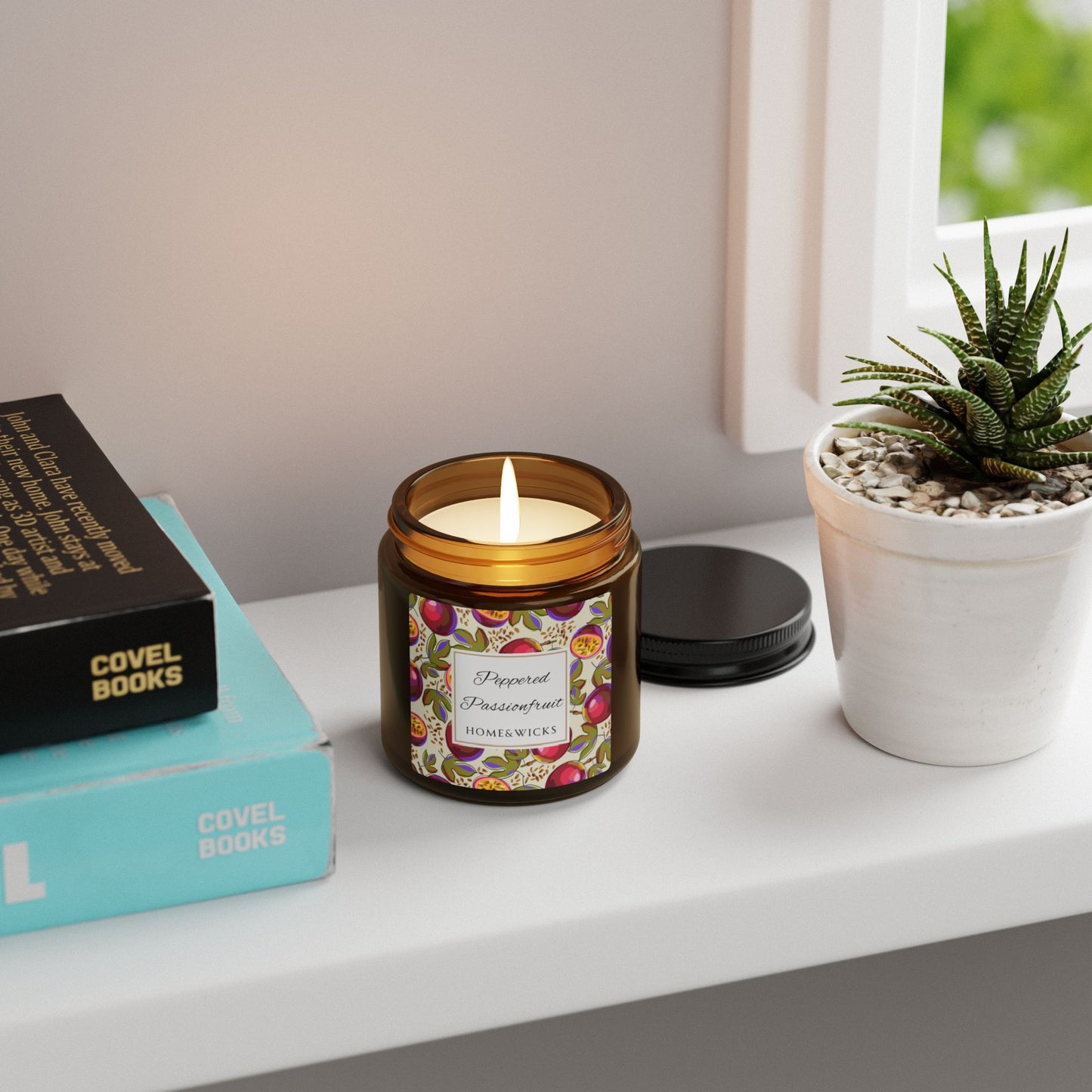 Candle in a decorative jar on a shelf with books and a plant