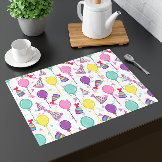 Happy Birthday 18” x 14” placemat with birthday hats, confetti and balloons pattern with a white background on a wood table