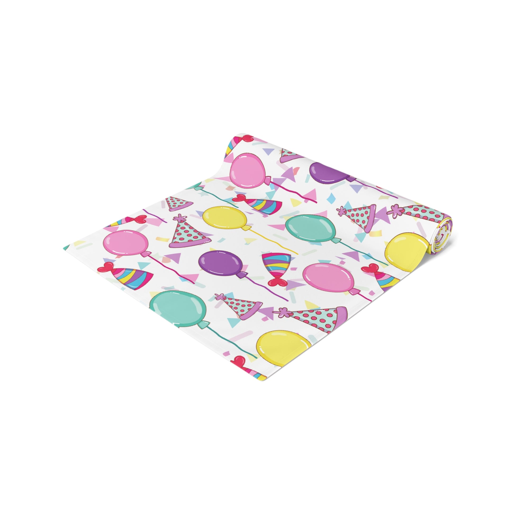 Rolled up table runner with birthday hats, confetti and purple, yellow, blue and pink balloons design on a white background 