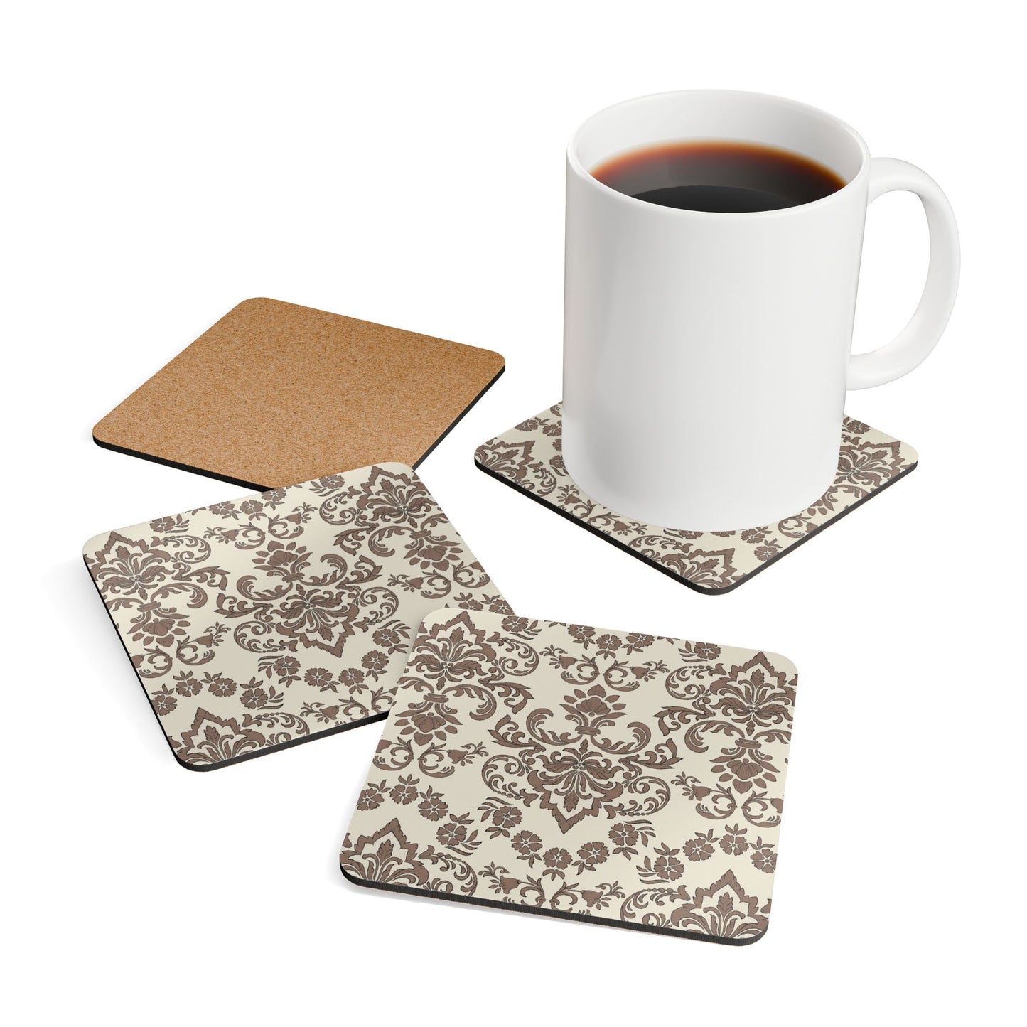 Set of four Baroque Mocha coasters with floral patterns and a white mug with coffee on a white background