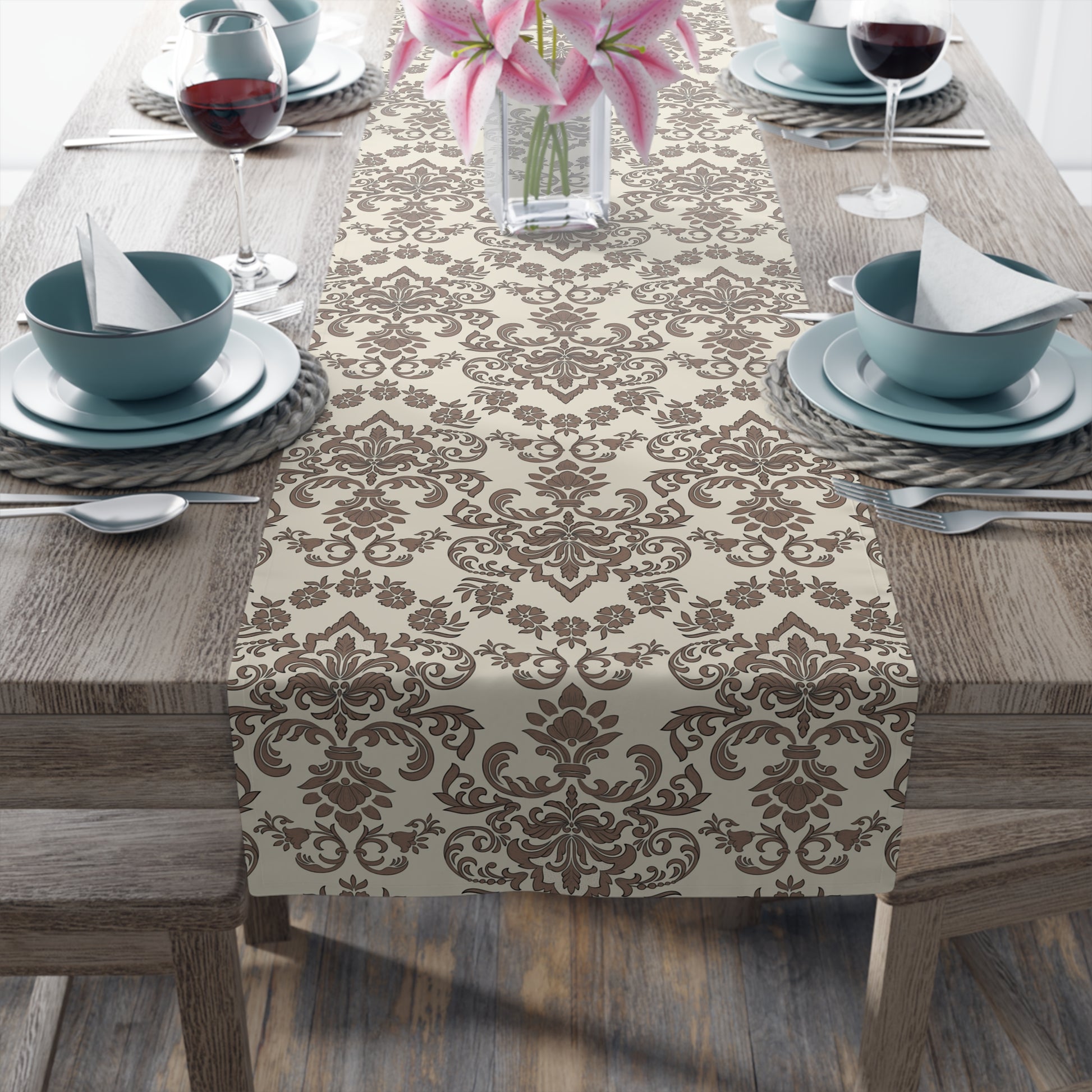 Table setting with a Baroque Mocha table runner with a brown and beige damask pattern on a wooden table.