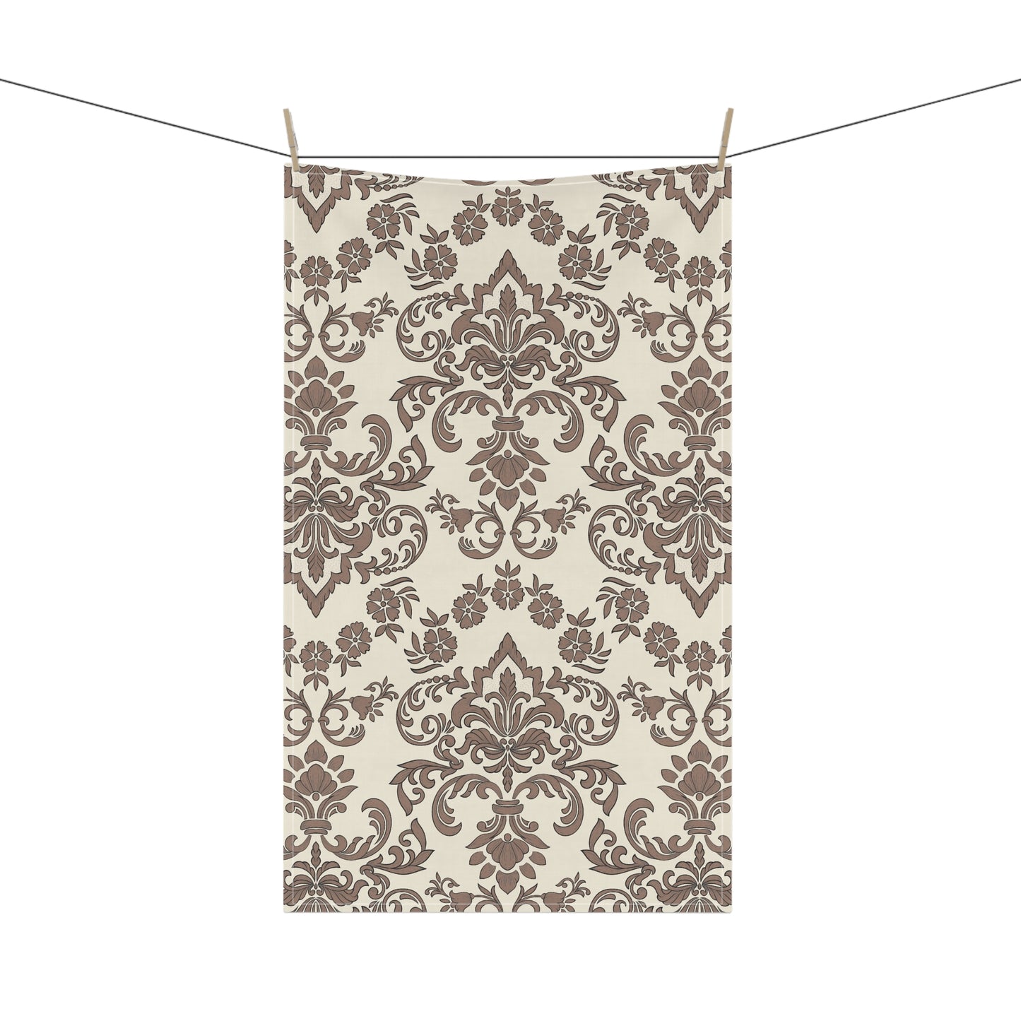 Decorative Baroque Mocha tea towel with brown damask pattern hanging on a line against a white background