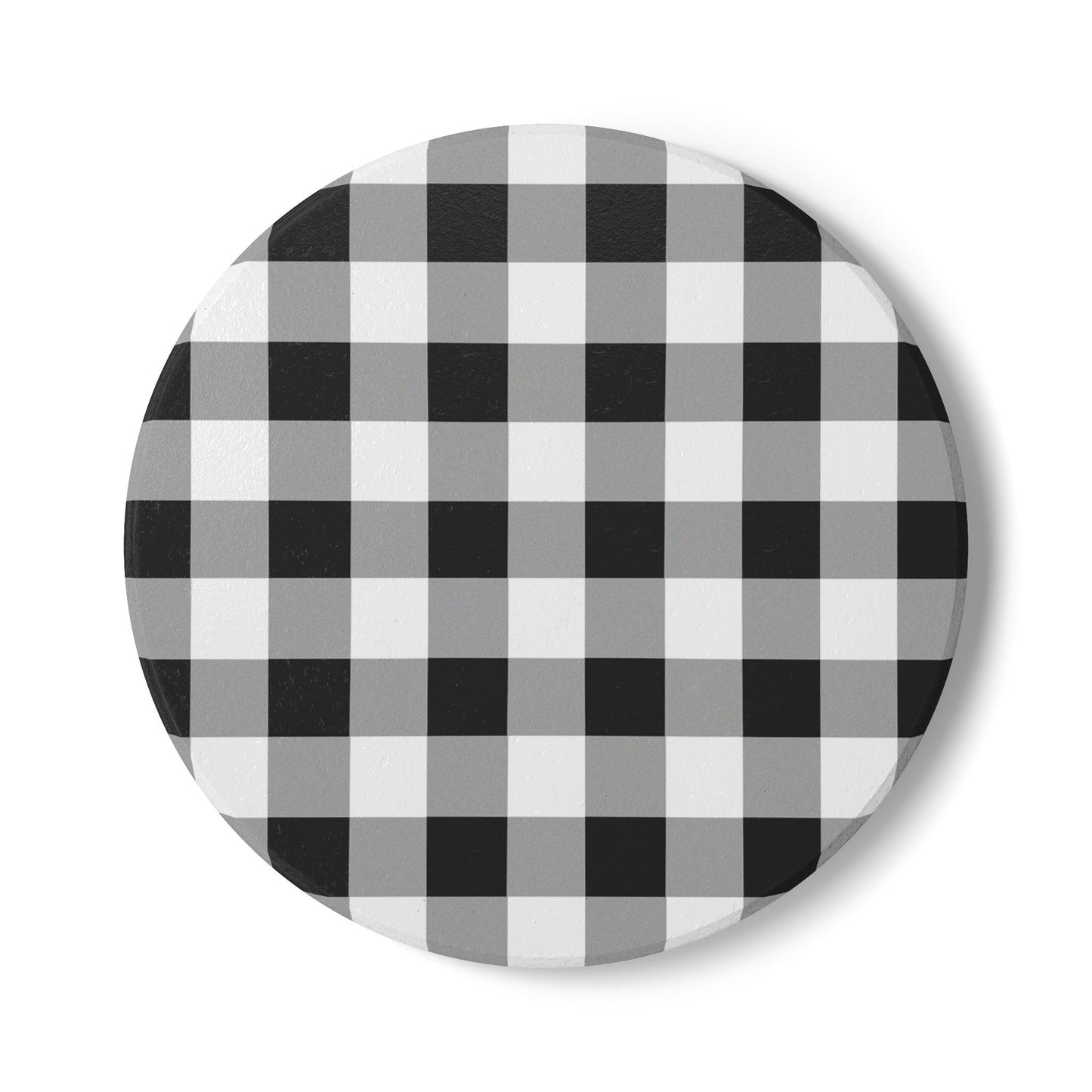 Round checkered black and white gingham patterned tile coaster on a white background