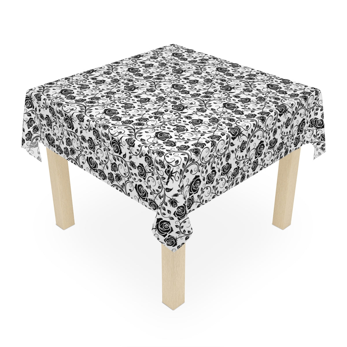 Small table with a black and white floral patterned tablecloth on a white background