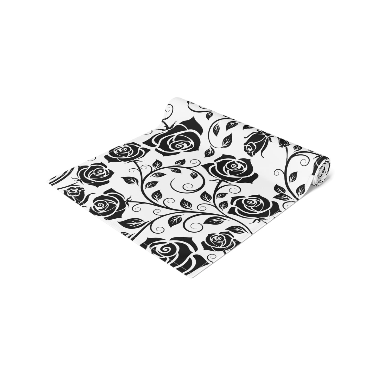 Floral patterned table runner with black roses rolled up on a white background