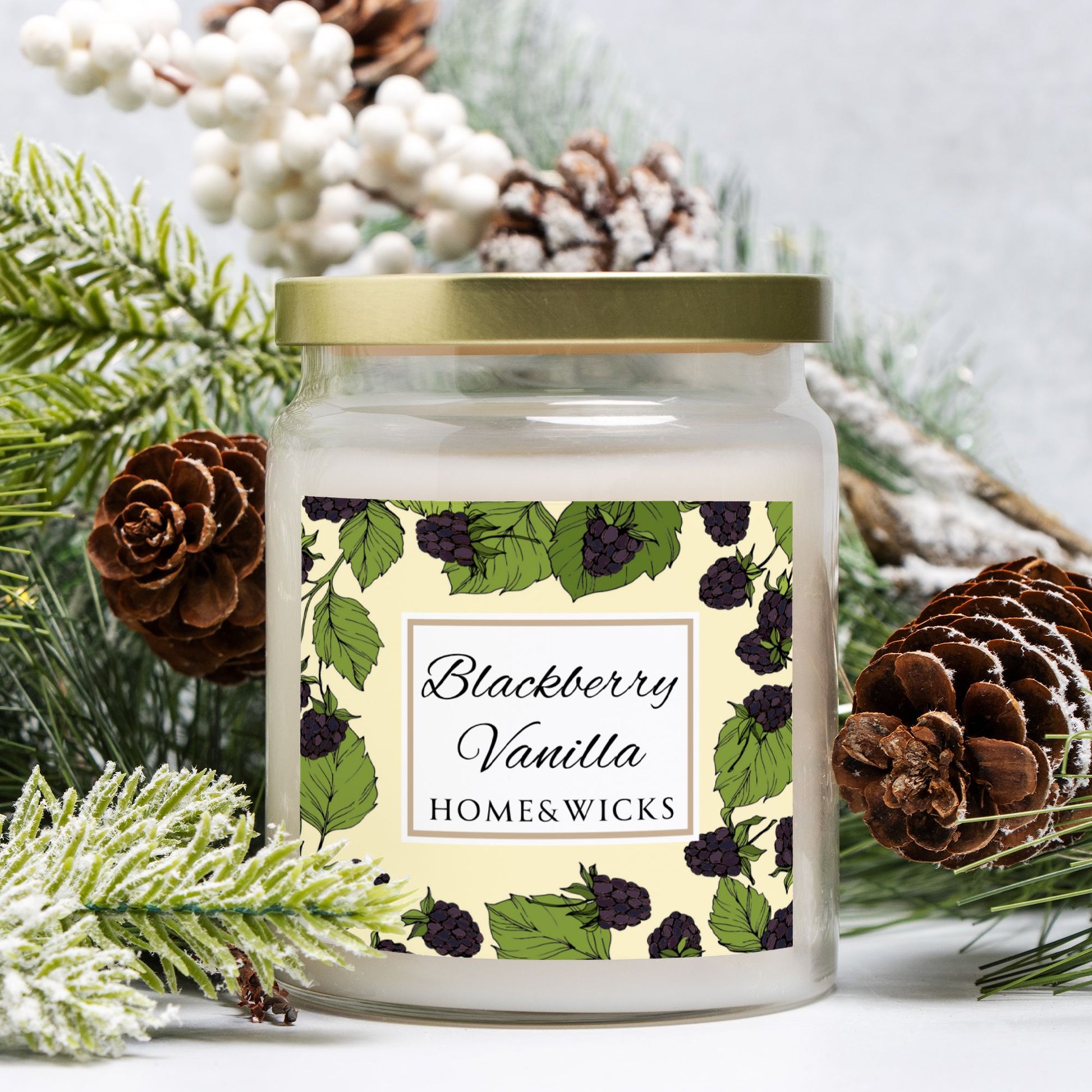 Candle jar with 'Blackberry Vanilla' label surrounded by pine cones and branches