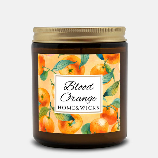 Blood Orange cotton wicked apricot coconut wax candle in an amber jar with gold lid and with 'Blood Orange' label and orange design on a white background by Home & Wicks