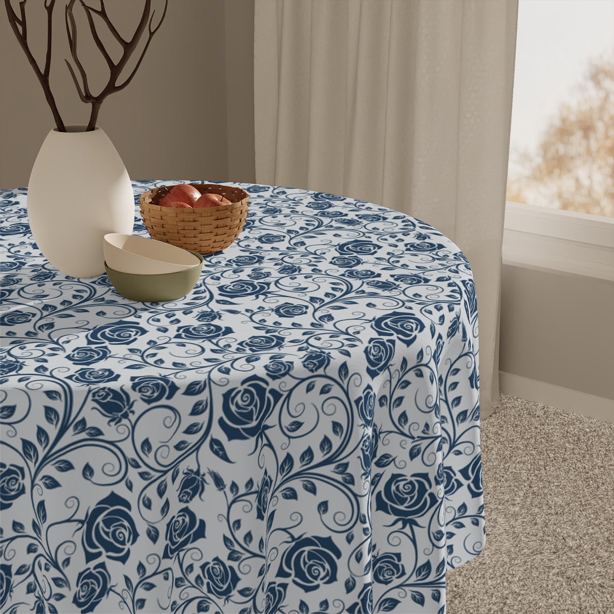 Blue floral patterned tablecloth on a table with decorative items.
