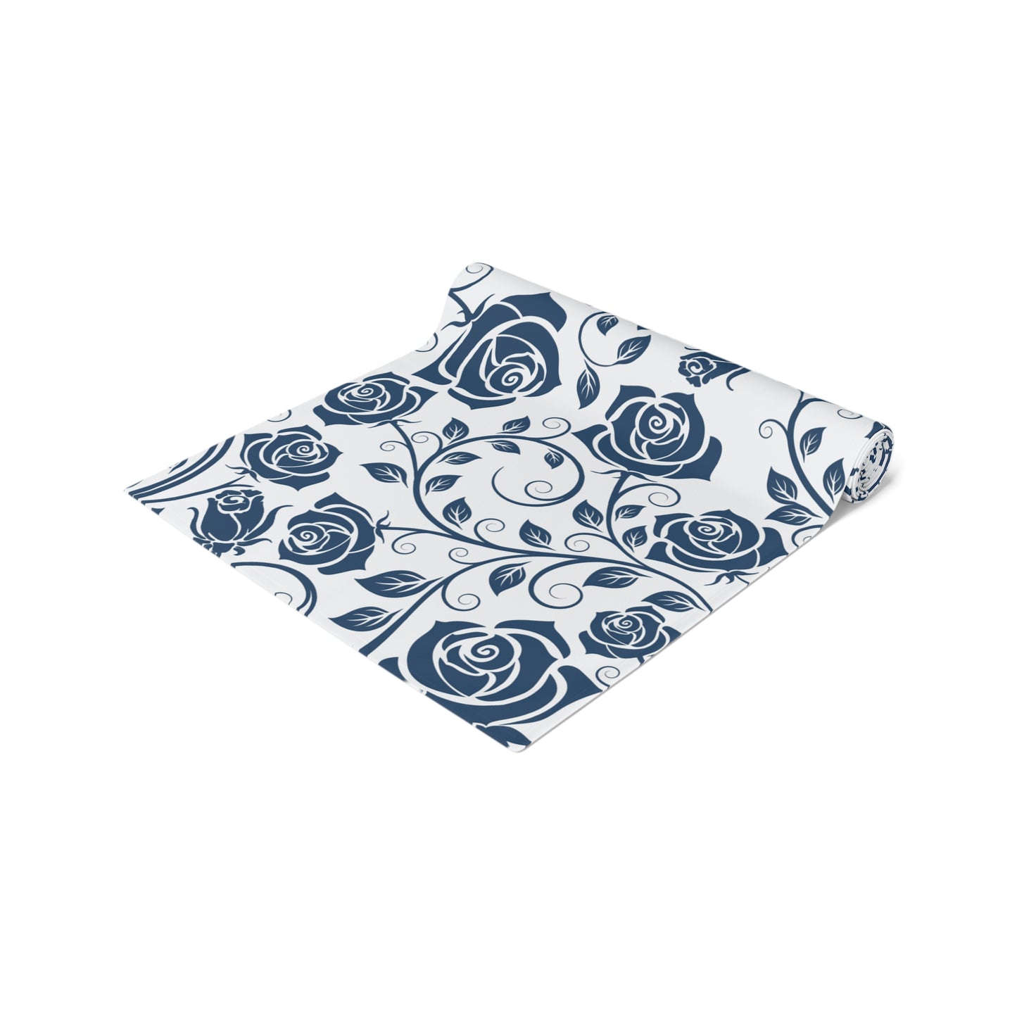 Floral patterned table runner with blue roses rolled up on a white background