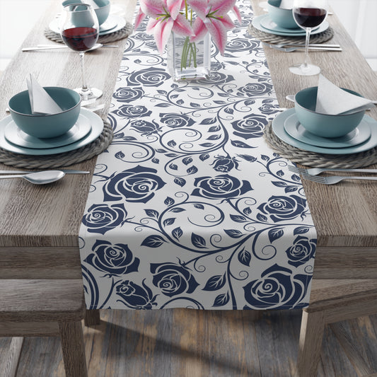 Table setting with a blue floral table runner on a wooden table.