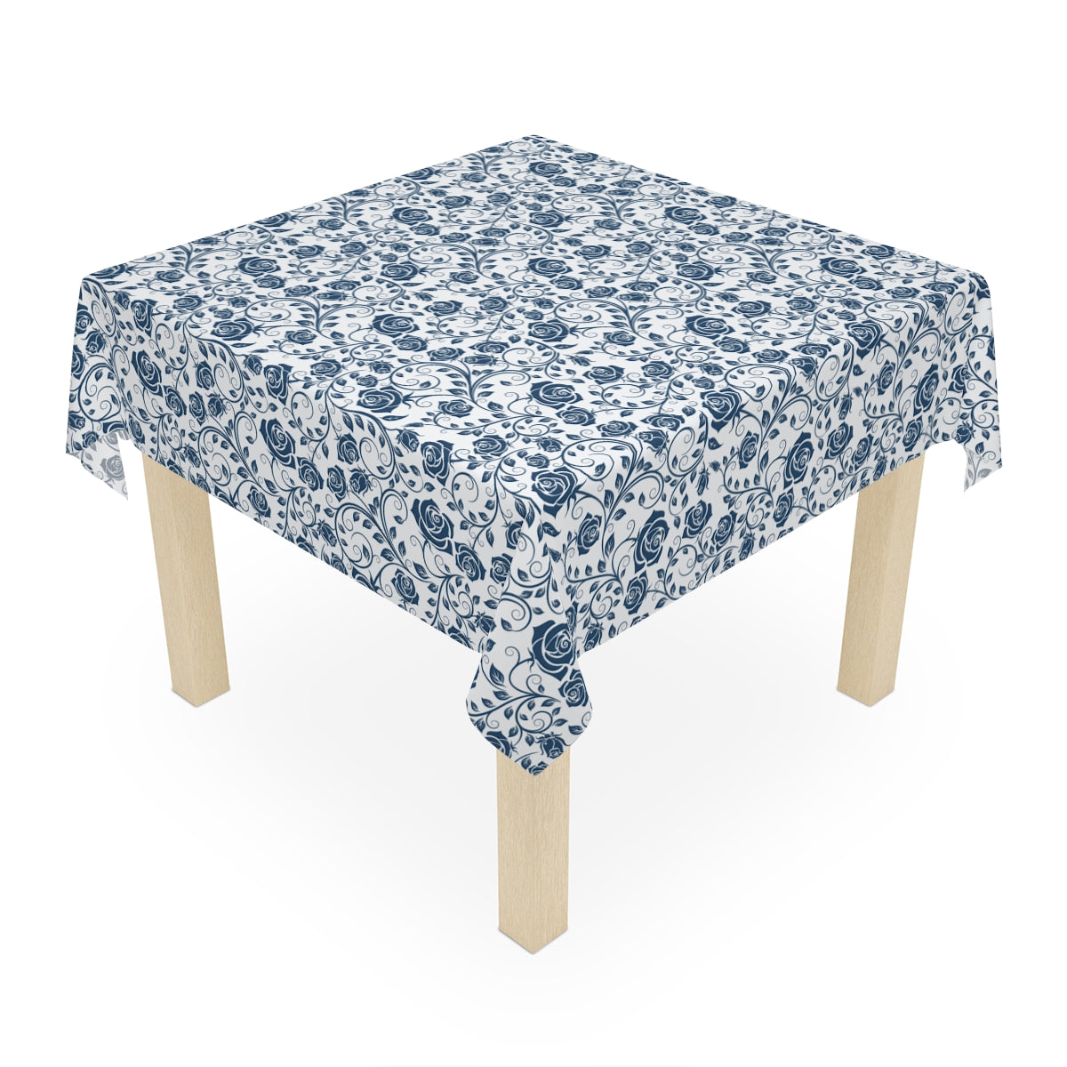 Table with a blue floral patterned tablecloth on a white background