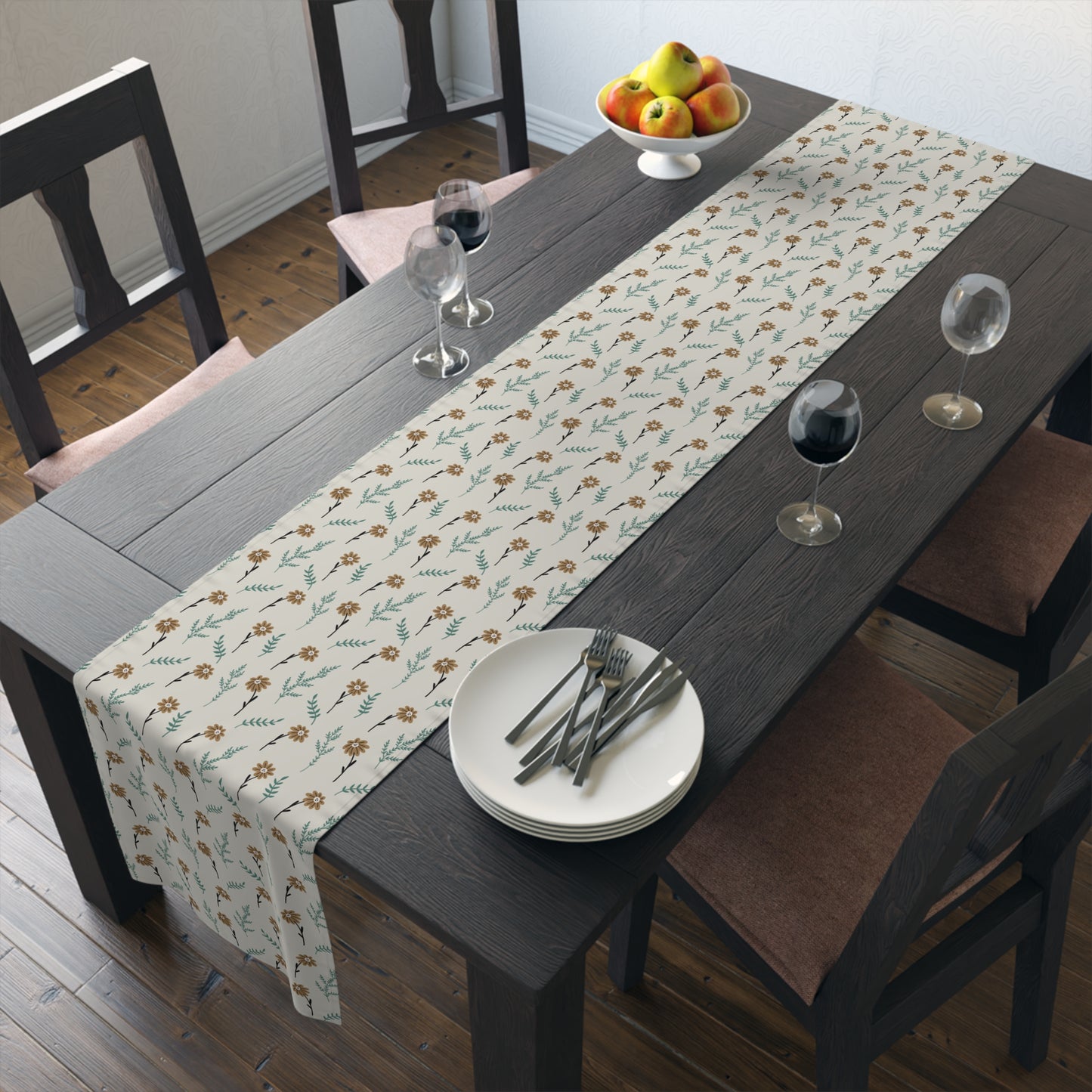 Dining table with our Brown Chamomile table runner that has a brown and gray floral-patterned table runner, plates, and glasses.