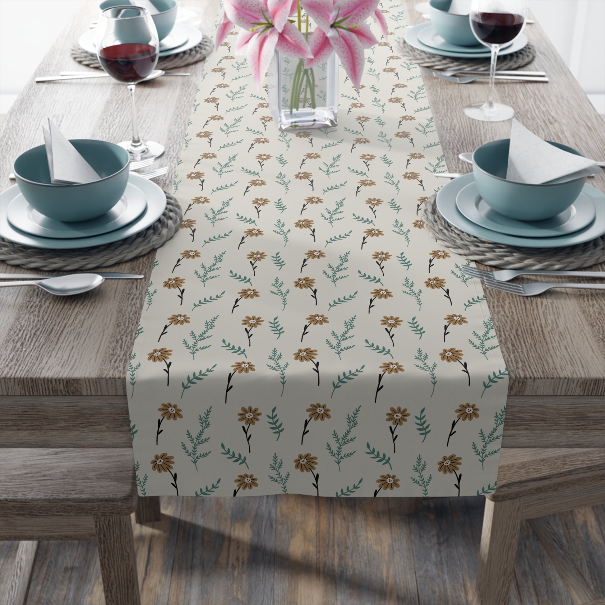 Table setting with our Brown Chamomile table runner that has a brown and gray floral-pattern on the table runner on a wooden table.
