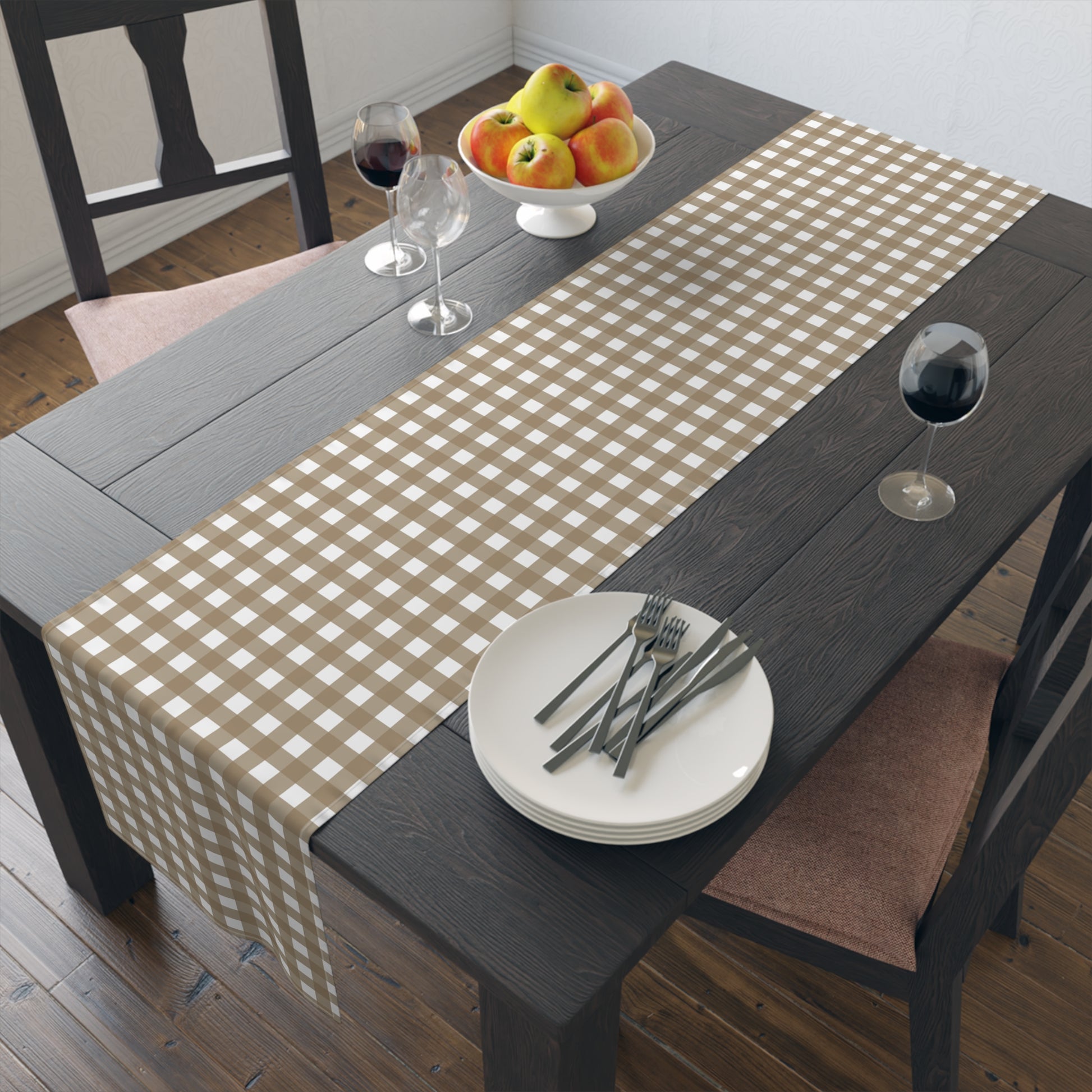 Our Brown Gingham checkered table runner on a wooden dining table with plates, forks, and fruit.