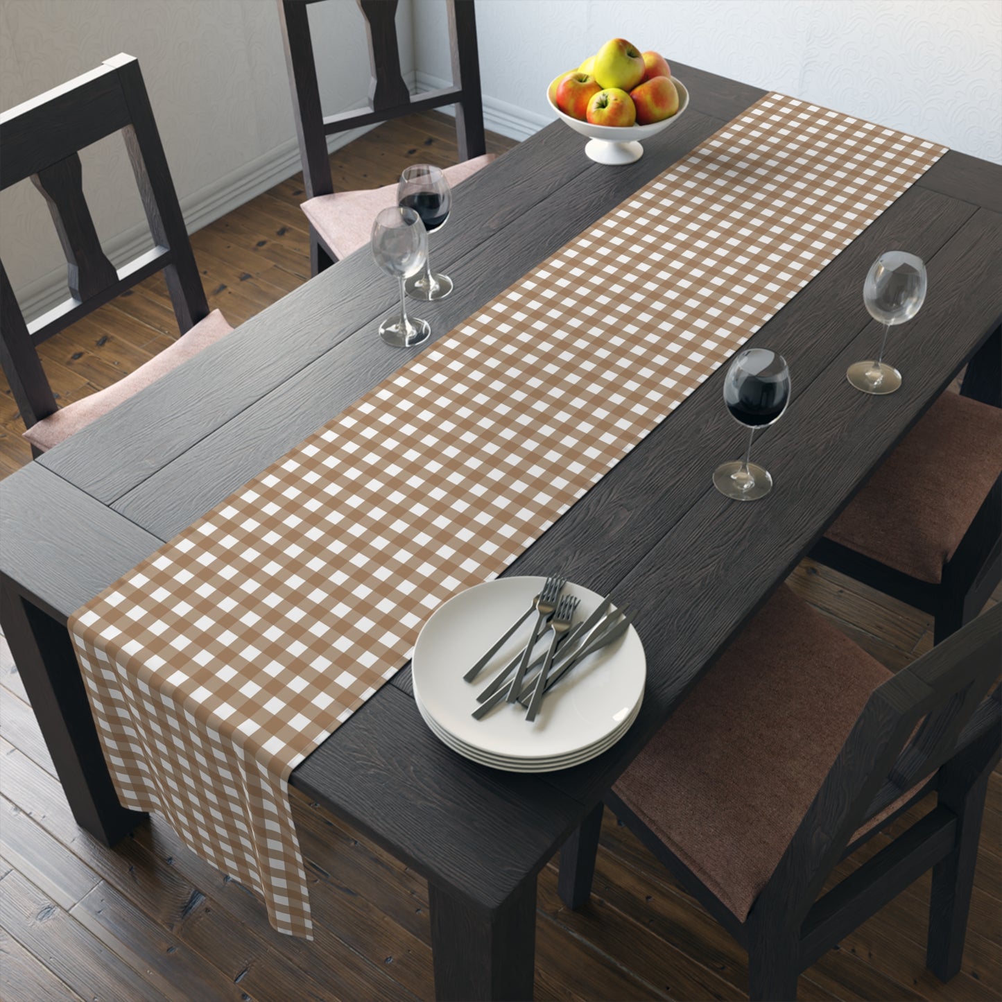 Dining table with our Brown Gingham checkered table runner, plates, and glasses in a room.