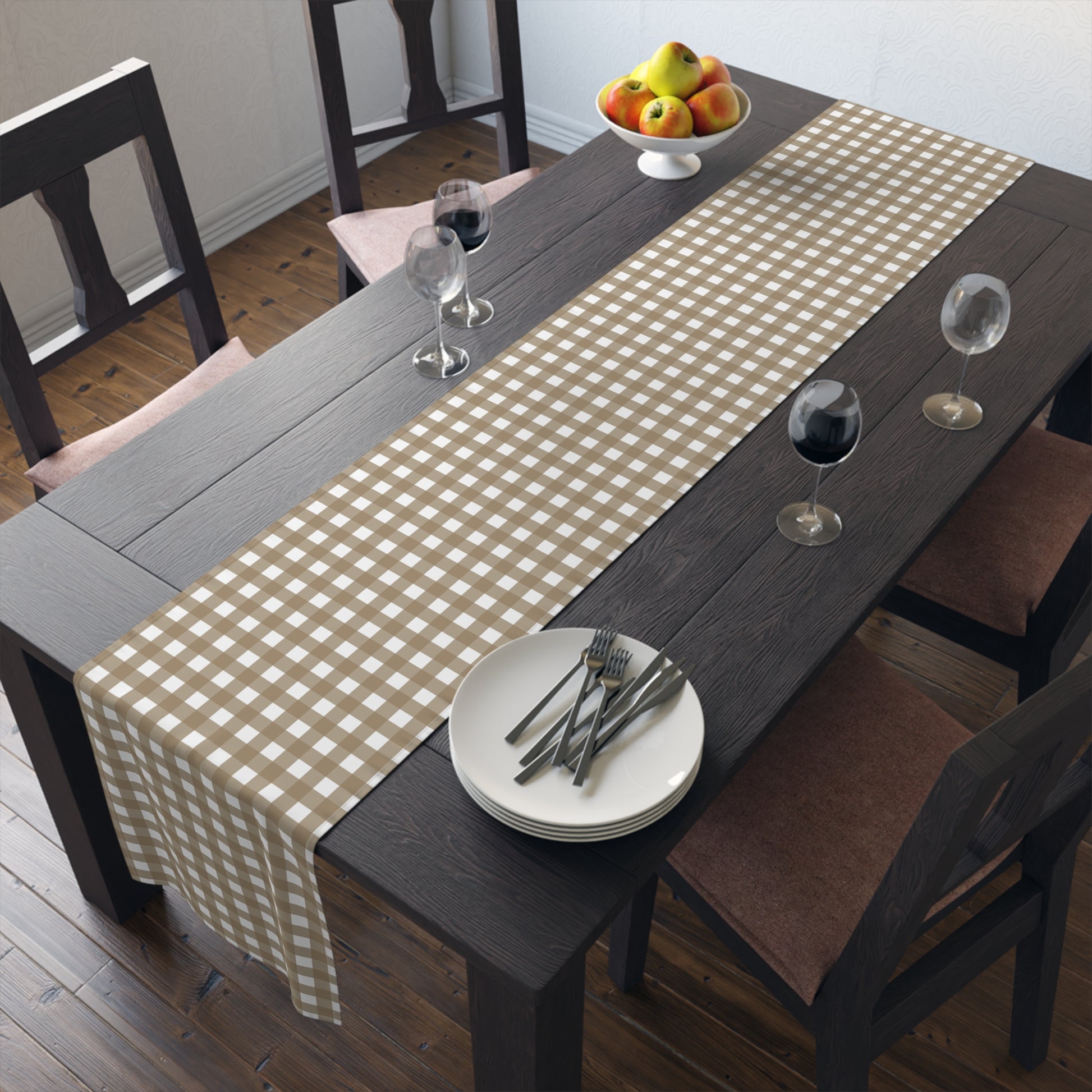 Dining table with our Brown Gingham checkered table runner, plates, and glasses in a room.