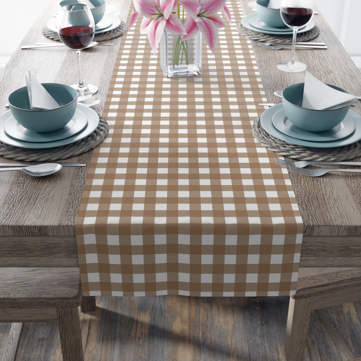 Dining table set with our Brown Gingham checkered table runner, blue bowls, and pink flowers.