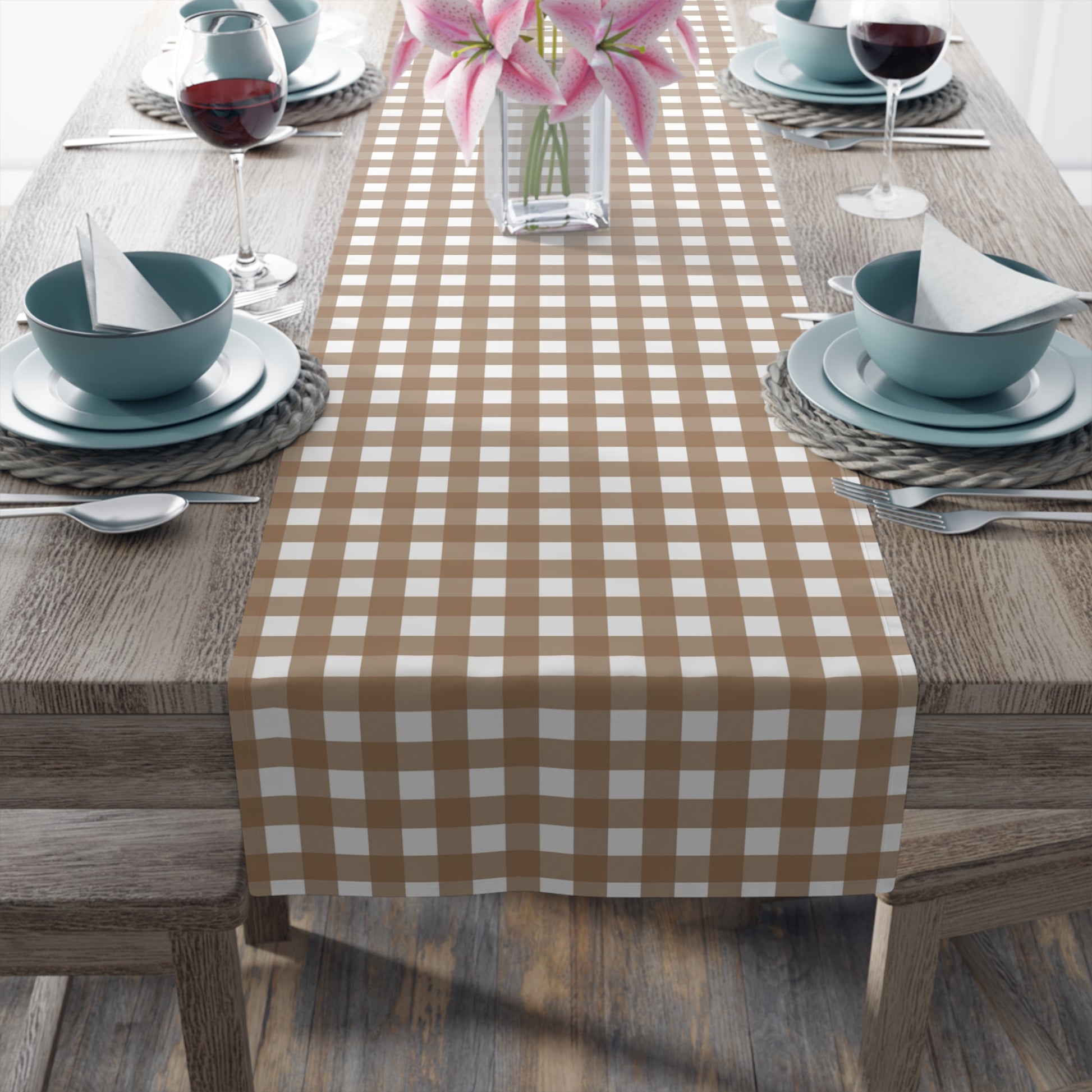 Dining table set with our Brown Gingham checkered table runner, blue bowls, and pink flowers.