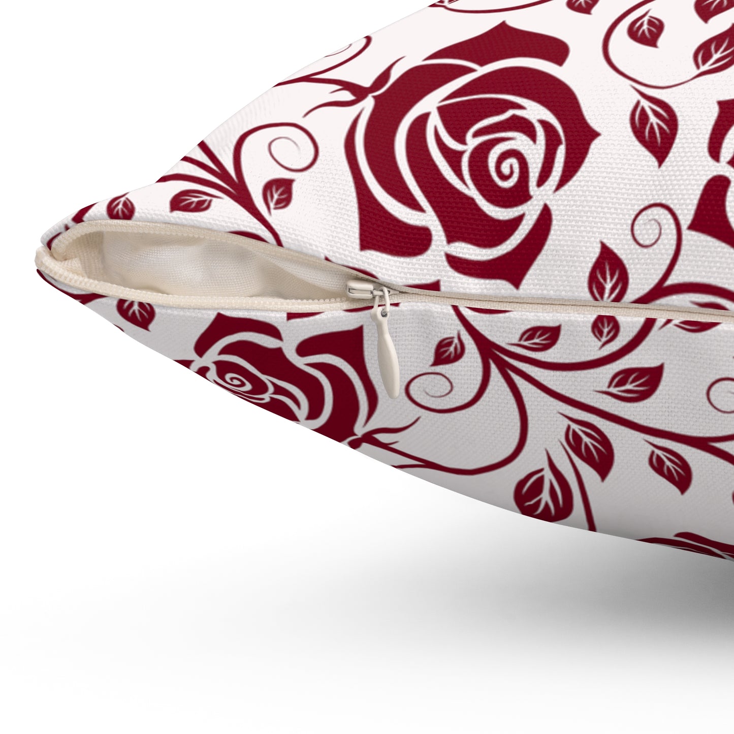 Pillow with burgundy red rose pattern with zipper closure on a white background