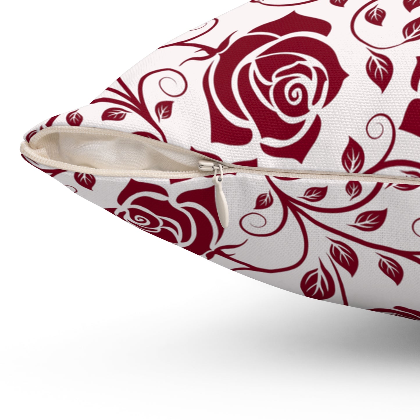 Pillow with burgundy red rose pattern  with zipper closure on a white background