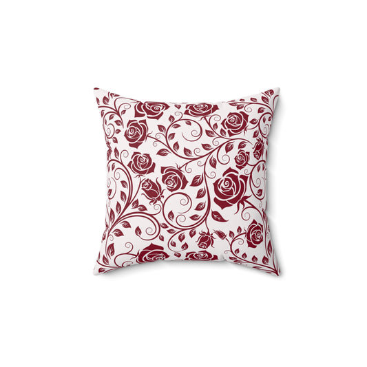Decorative pillow with burgundy red rose pattern on a white background