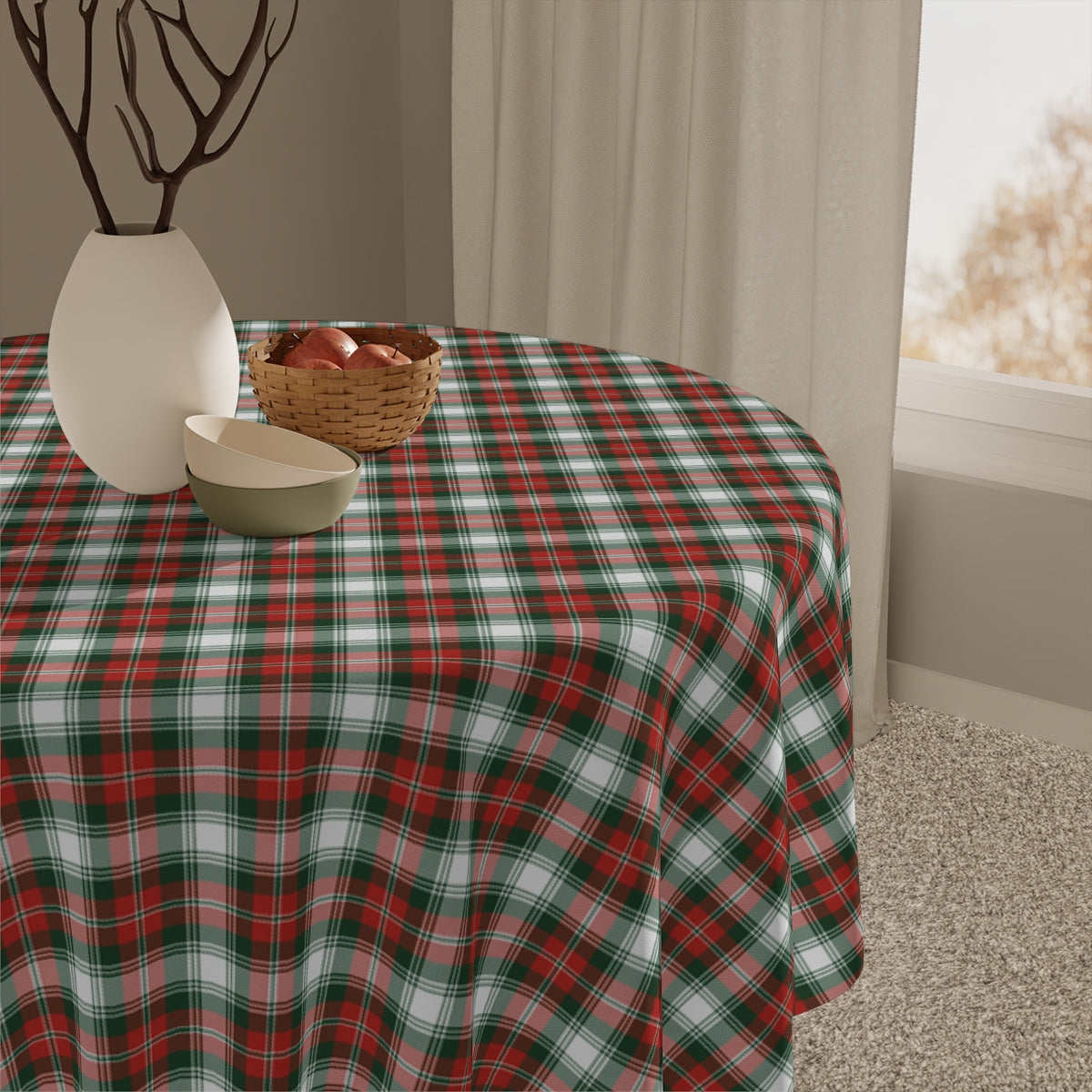 Round table with a red and green plaid tablecloth, accompanied by decorative items.