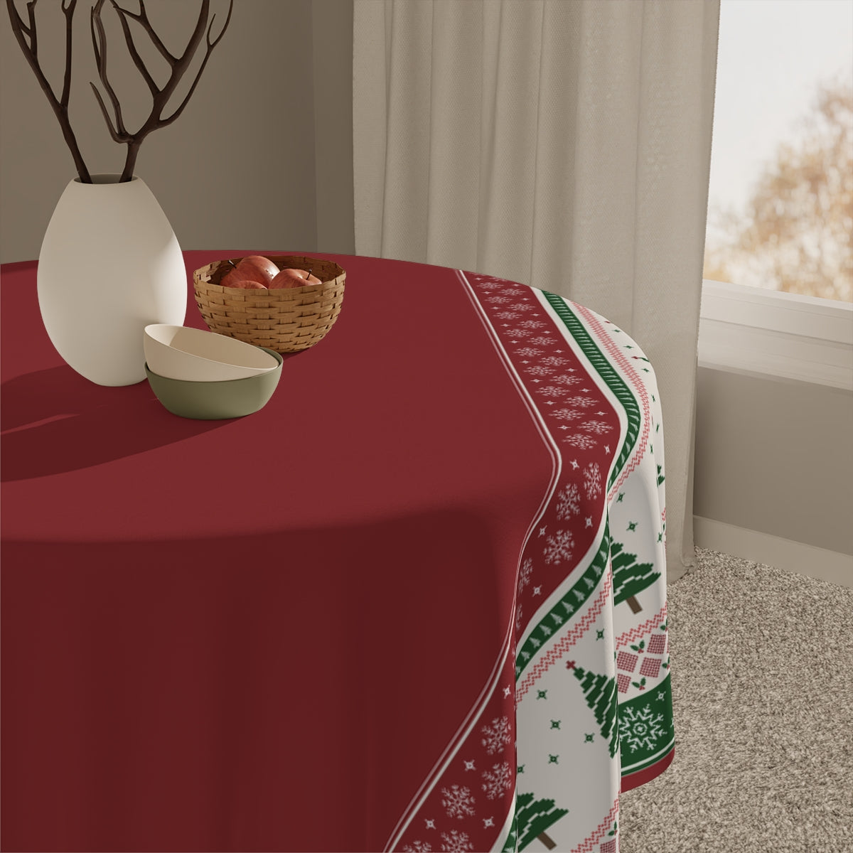 Red tablecloth with tablecloth with Christmas trees and snowflakes red and green pattern on a table, with decorative items including a vase and basket.