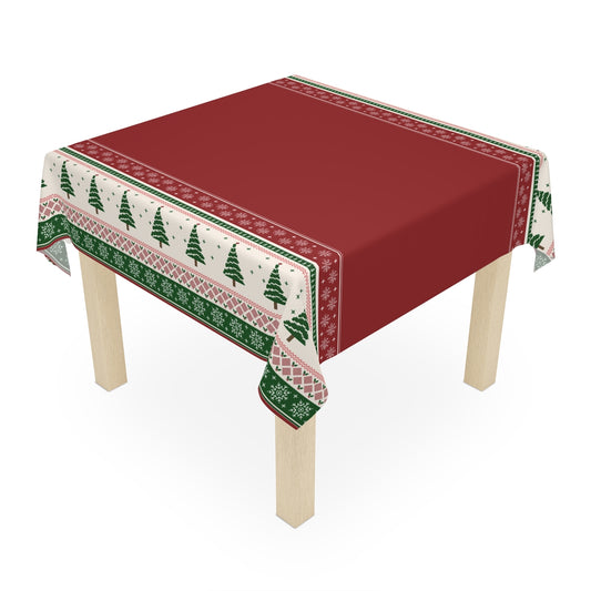 Red tablecloth with Christmas trees and snowflakes red and green pattern on a wooden table