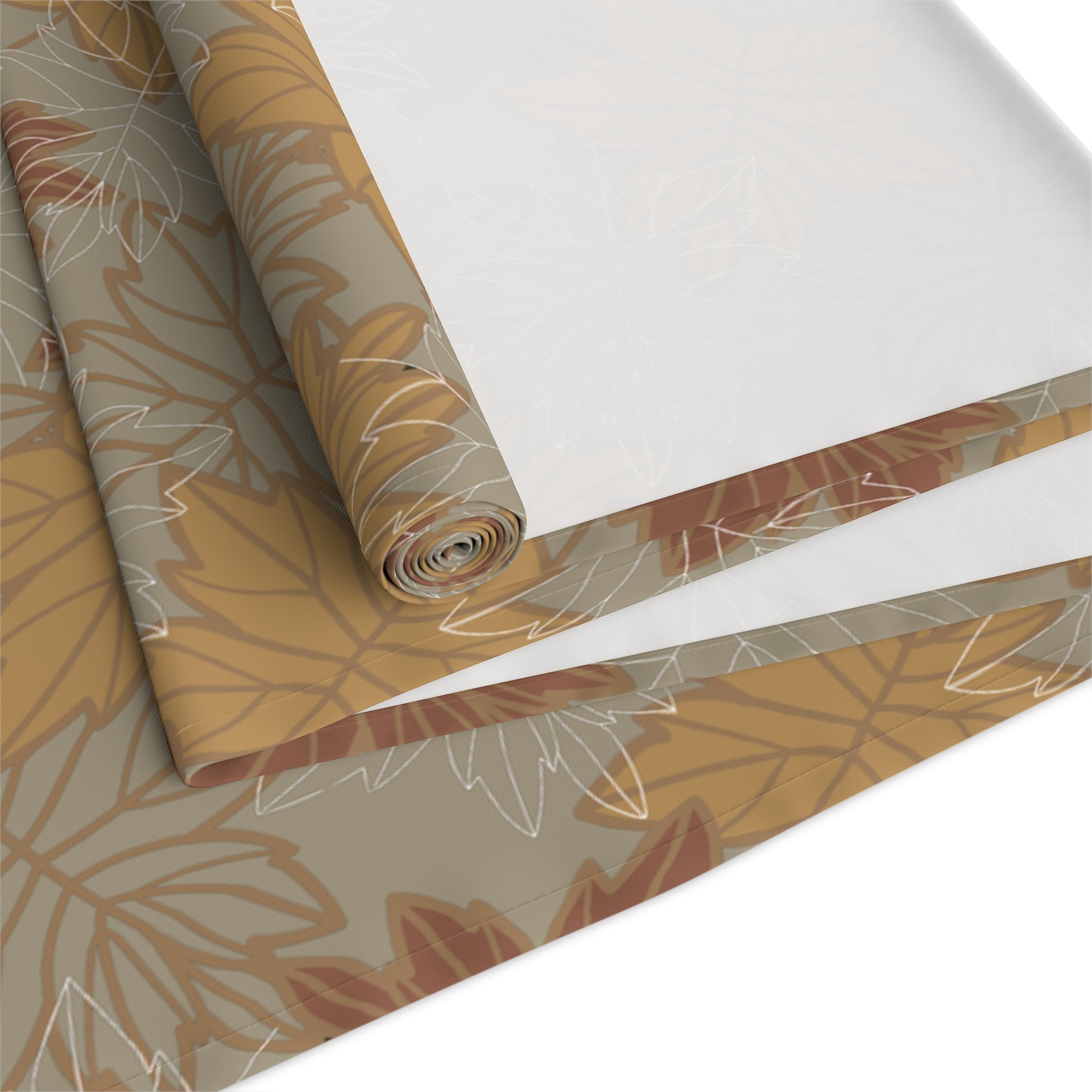 Roll of fall autumn leaf patterned table runner with brown and beige leaves on a white background
