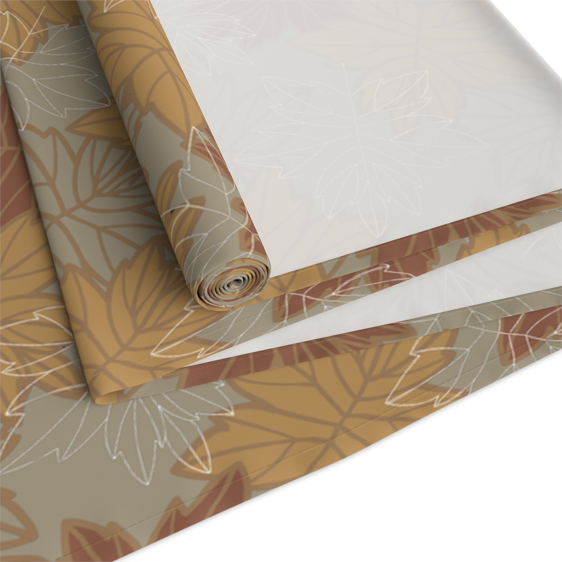 Roll of decorative table runner with leaf pattern on a white background