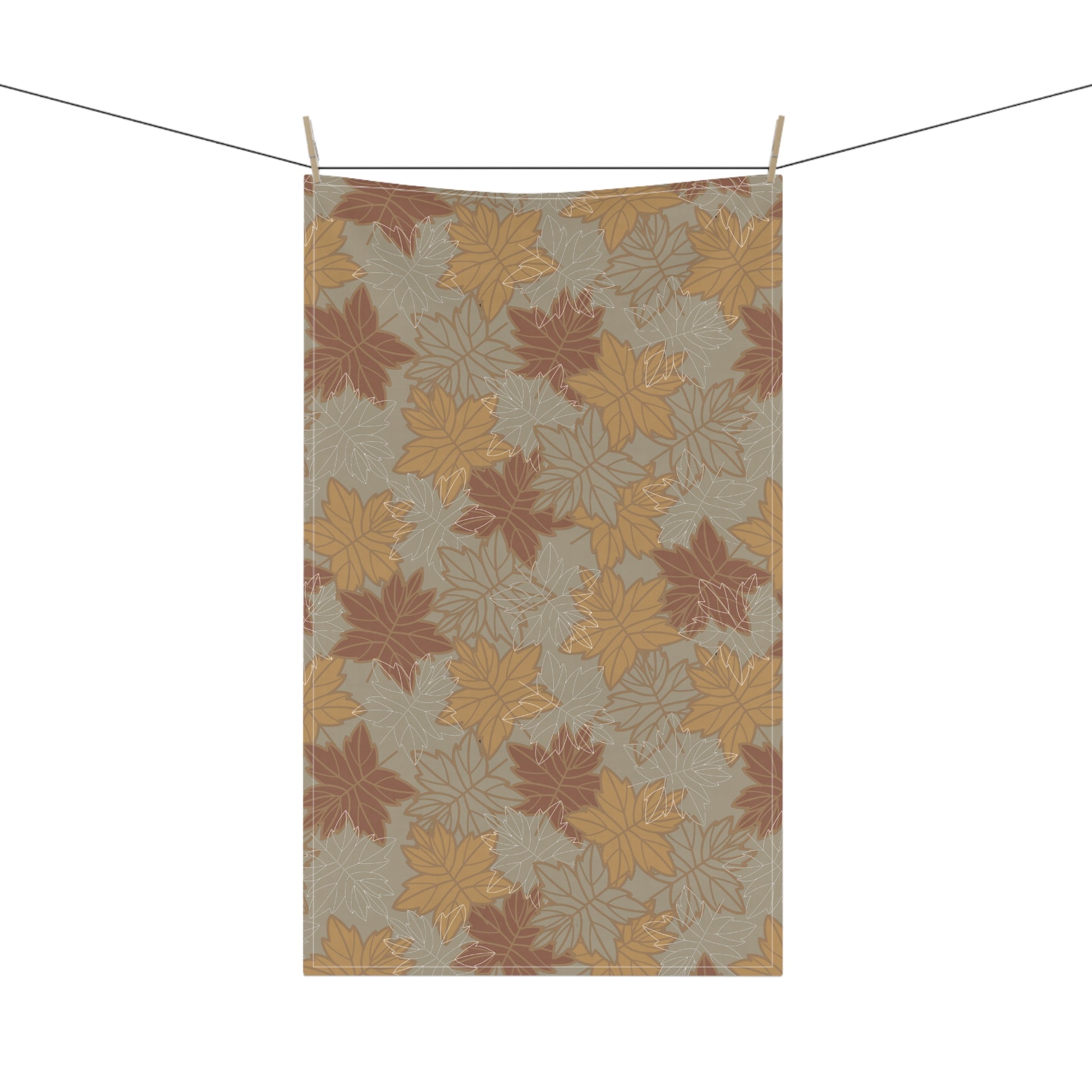 Kitchen tea towel with autumn leaf pattern hanging on a line