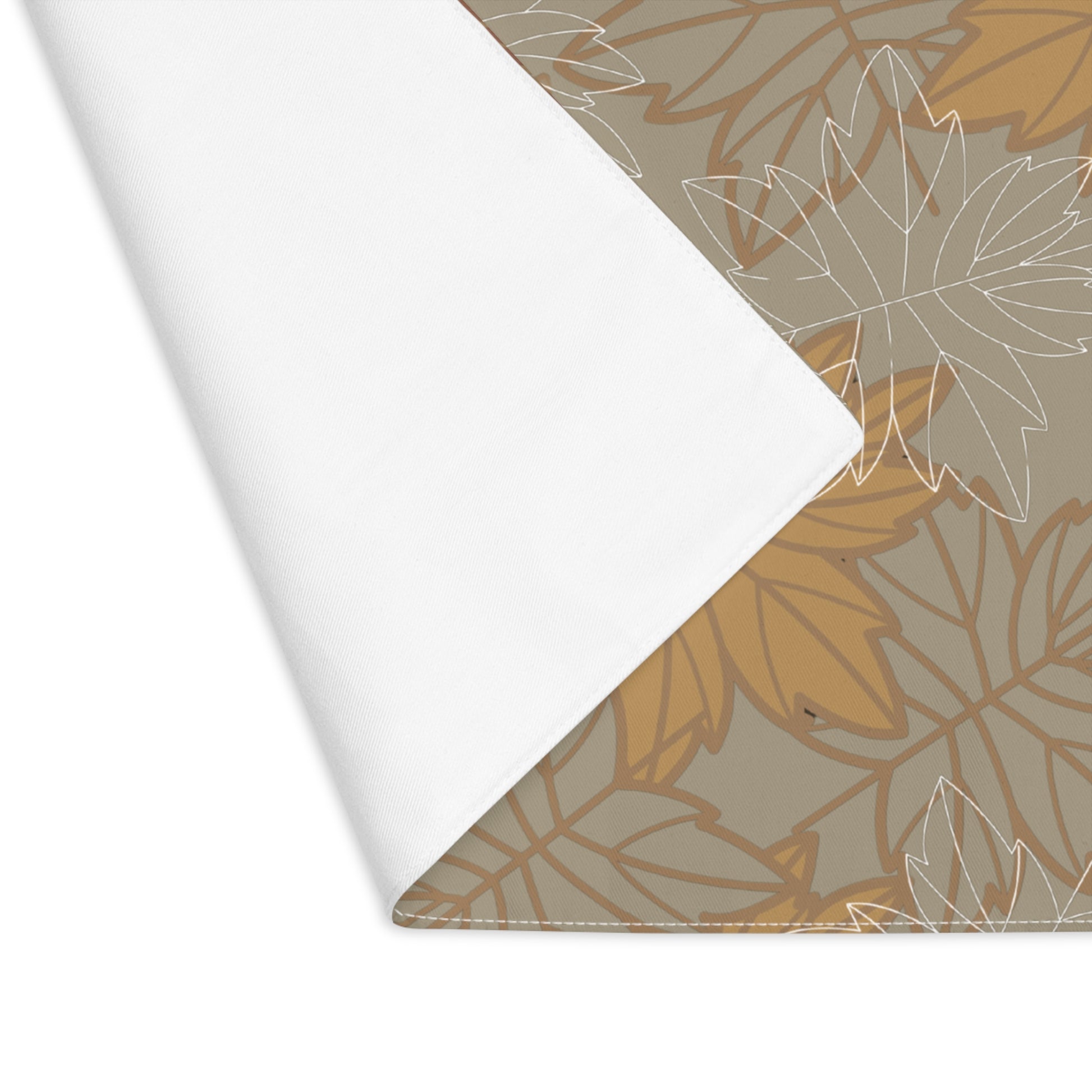 Corner folded for white back view of our Earthy Leaves placemat with leaf pattern in gold, brown and olive green-gray on a white background