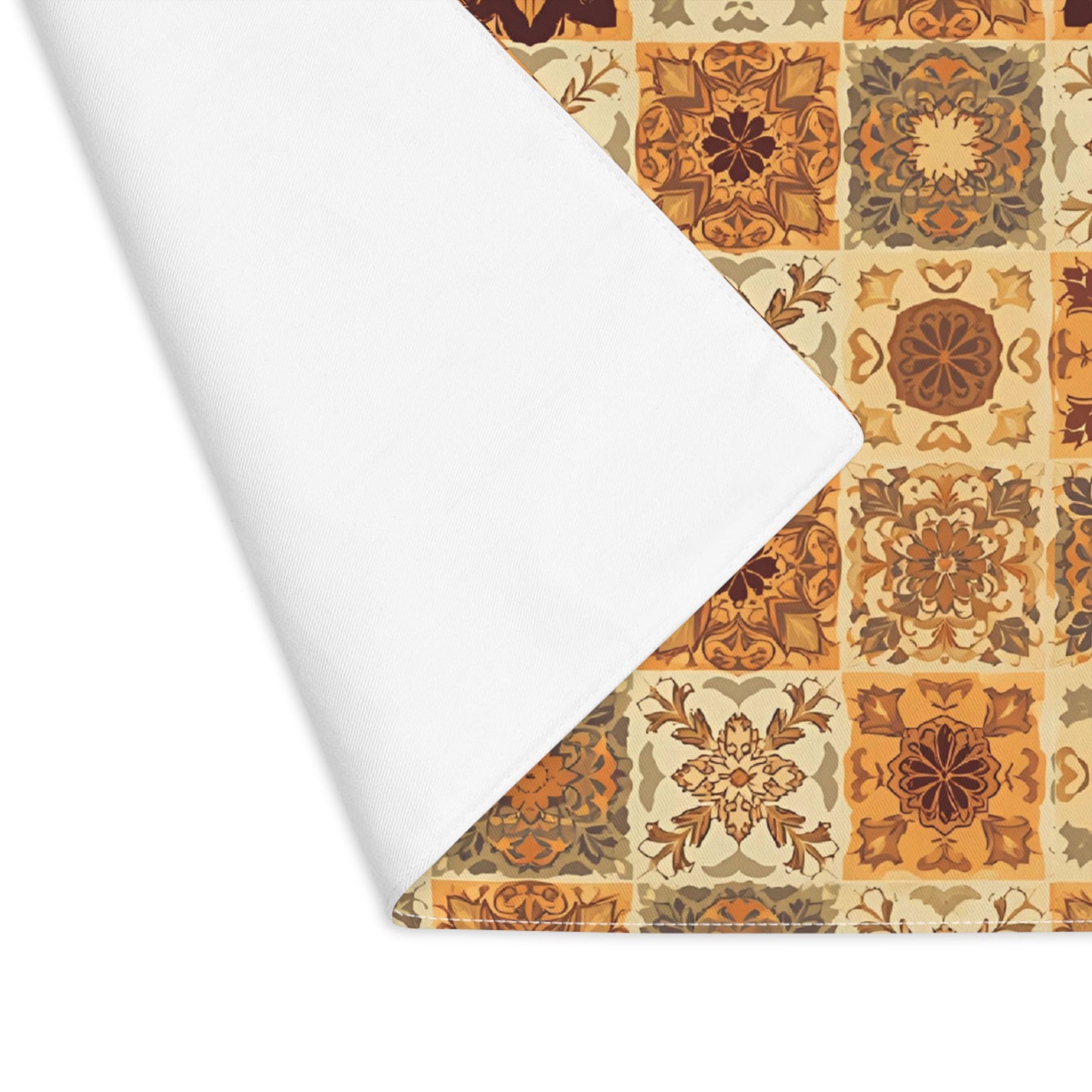 This cotton twill Fall Flowers Mosaic placemat has brown, green and gold floral square geometric pattern. This placemat's corner if folded over to reveal the white backside and is on a white background.