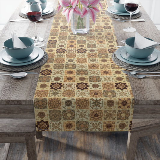 Our Fall Flowers Mosaic table runner has a brown, green and gold floral square geometric pattern. This table runner is on a wooden table with dining setup