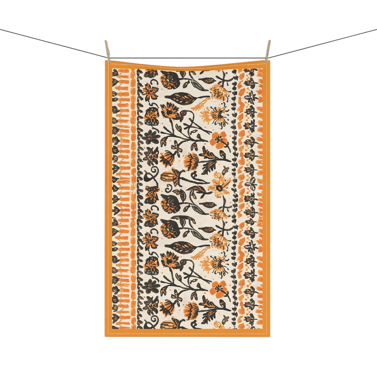 Orange and black floral patterned towel hanging on a line with orange border
