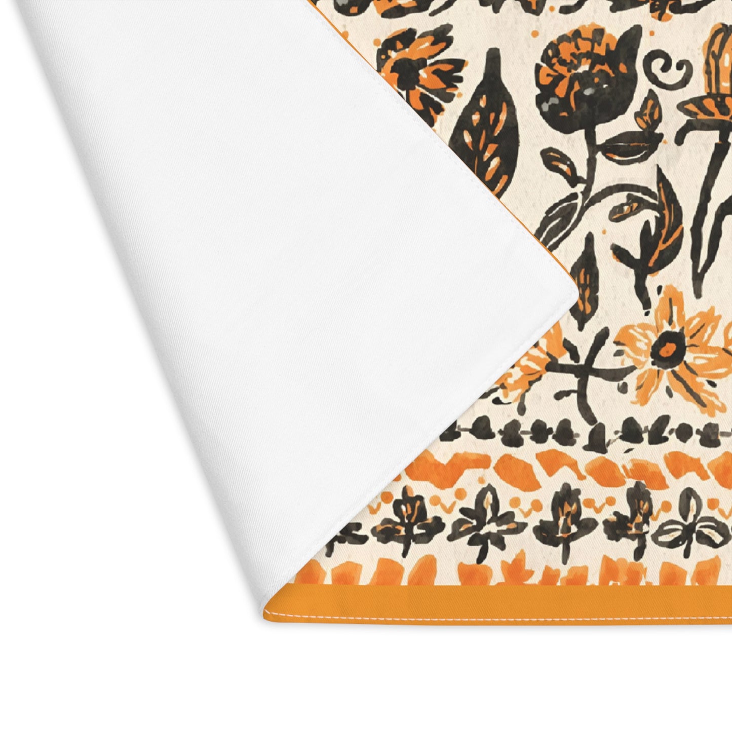 Fall Flowers placemat, with a boho orange and black floral pattern, is printed on a cotton twill placemat fabric,  with corner folded over to reveal white backside, on a white background
