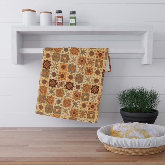Fall colored floral patterned towel hanging on a wooden shelf with a plant and basket in the foreground.