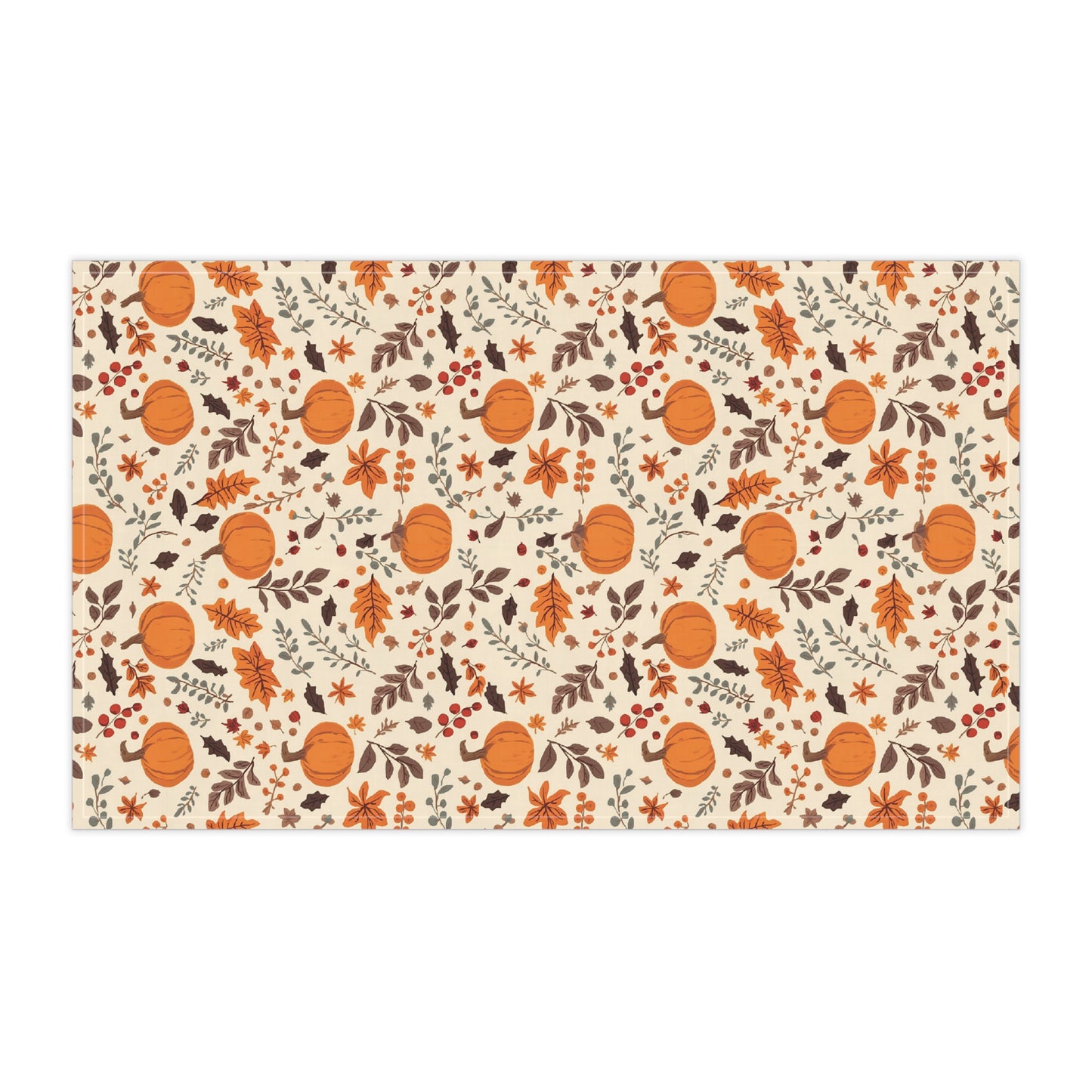 Patterned kitchen tea towel with pumpkins and leaves on a beige background