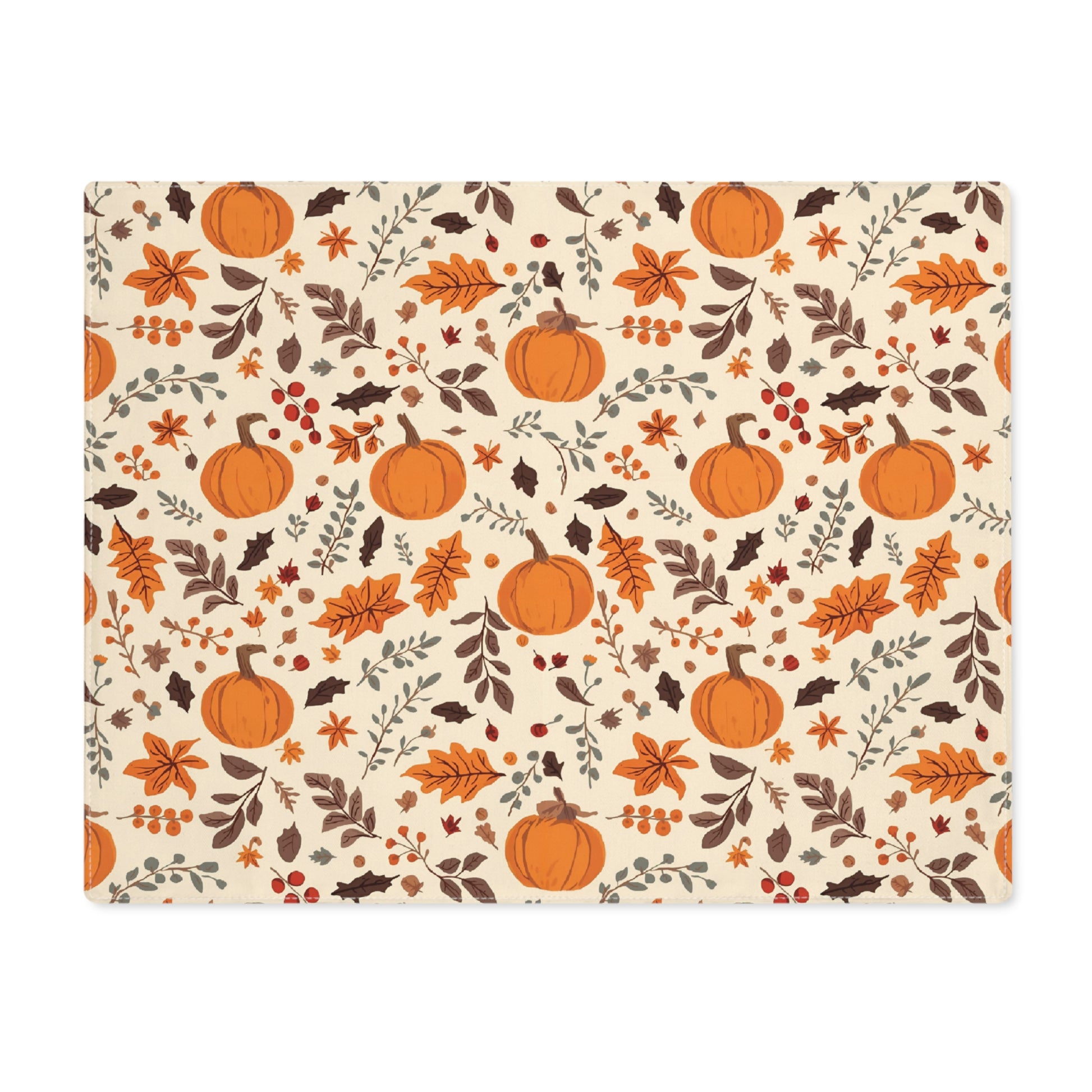 Fall Leaves and Pumpkins placemat has brown and orange fall leaves with orange pumpkins with a beige background, design printed on the table runner cotton twill  fabric, shown on a white background.
