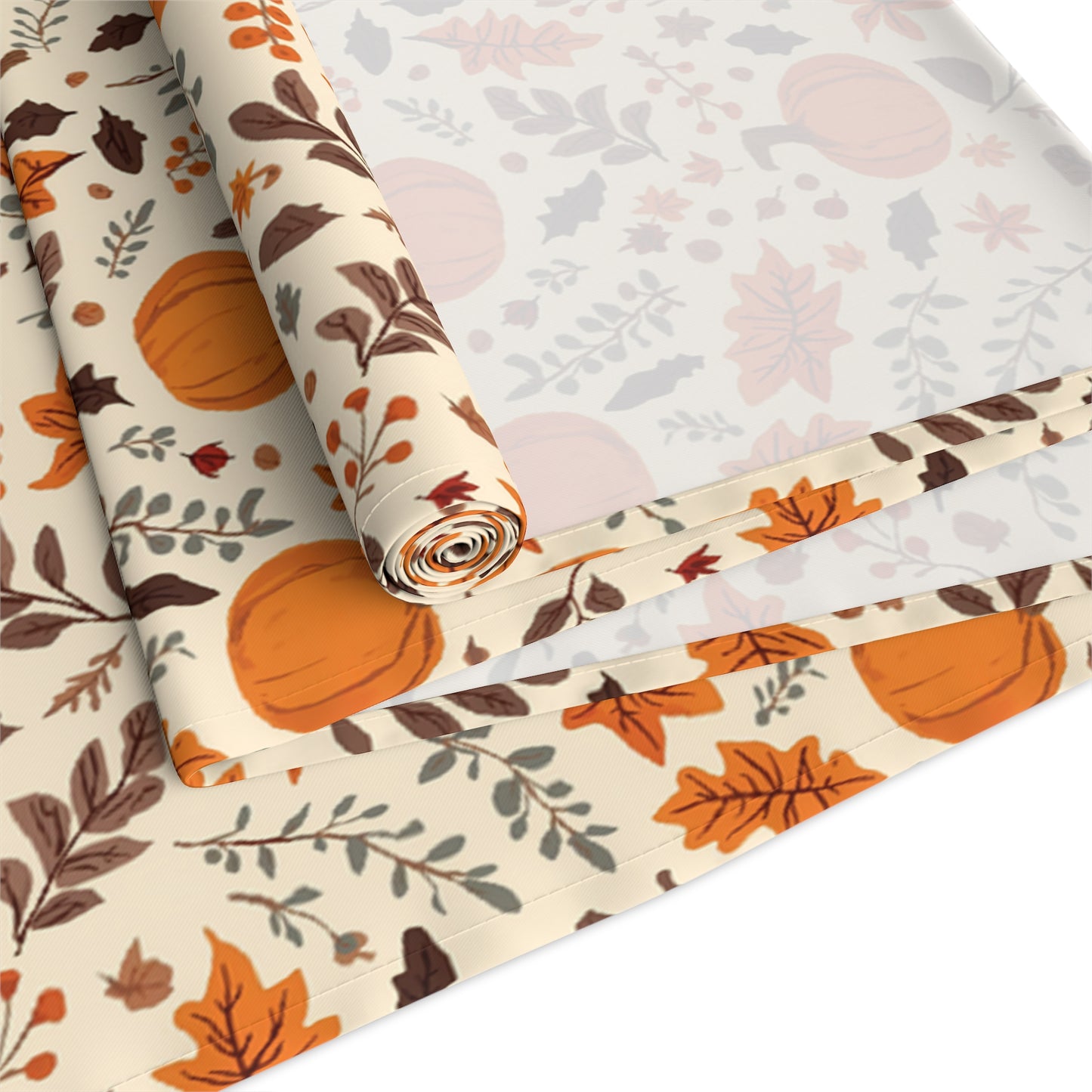 Fall Leaves and Pumpkins table runner has brown and orange fall leaves with orange pumpkins with beige background printed on the table runner shown rolled up and folded on a white background.