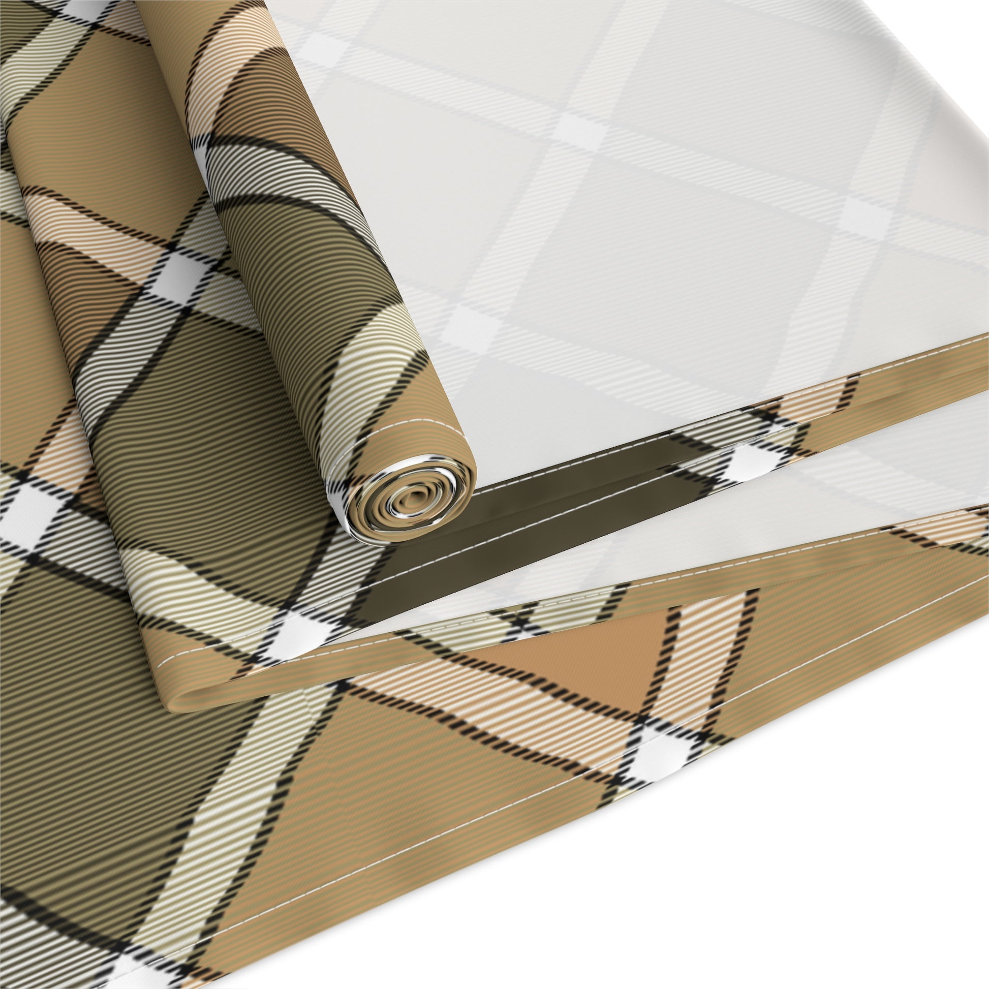 Our Fall Plaid table runner has brown, green, orange plaid patterned colors. The table runner is rolled up on a white background.