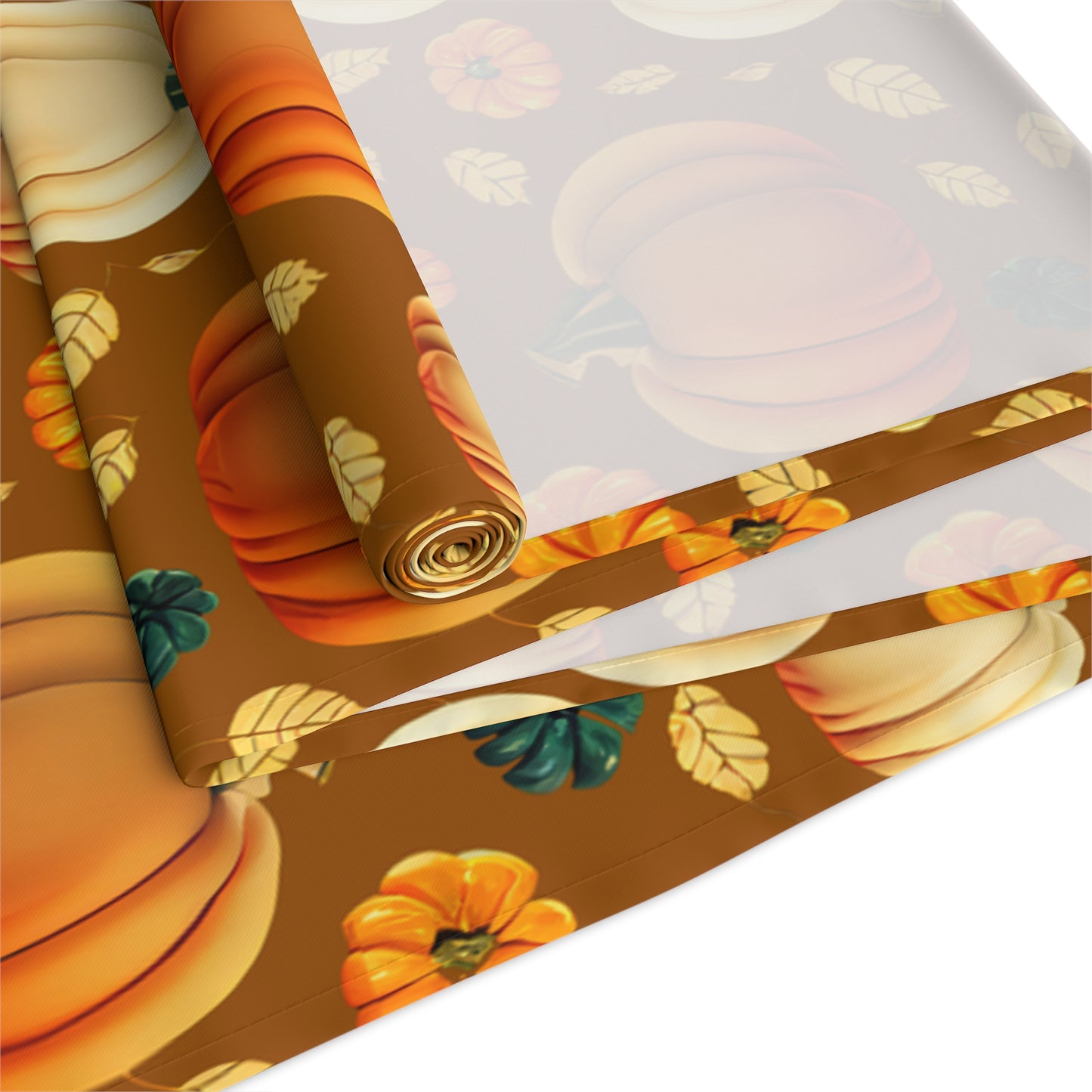 Fall Pumpkins table runner with a pumpkin-themed pattern printed on front of table runner, rolled up and folded on a white background