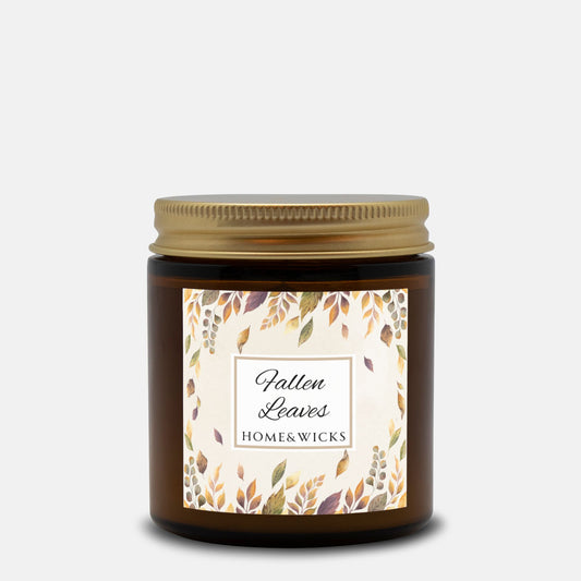 Amber candle jar with 'Fallen Leaves' label on a white background
