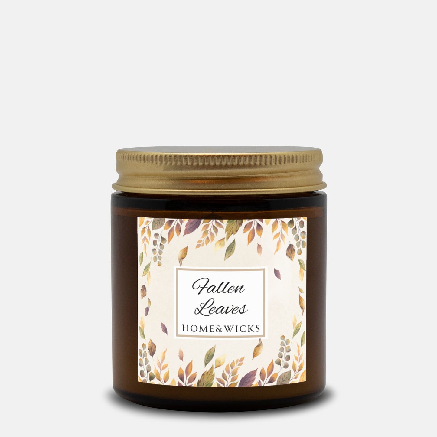 Amber candle jar with gold lid and 'Fallen Leaves' label on a white background