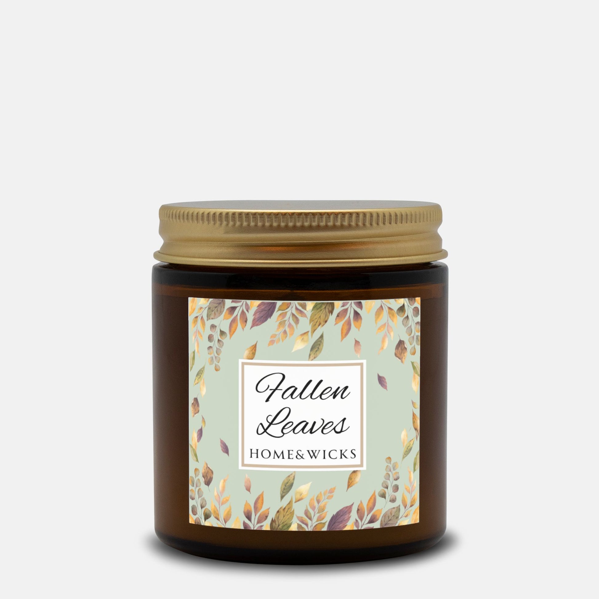 Fallen Leaves candle in a 4 oz. amber glass jar with gold lid with a 'Fallen Leaves' label on a white background by Home & Wicks
