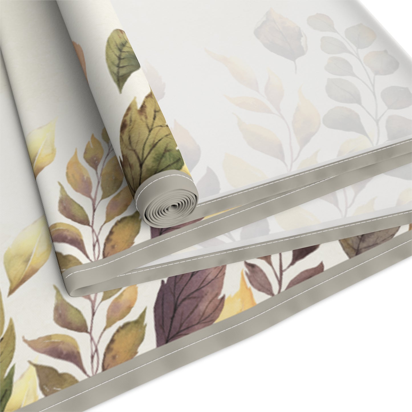 Roll of Fallen Leaves table runner with leaf pattern on a white background
