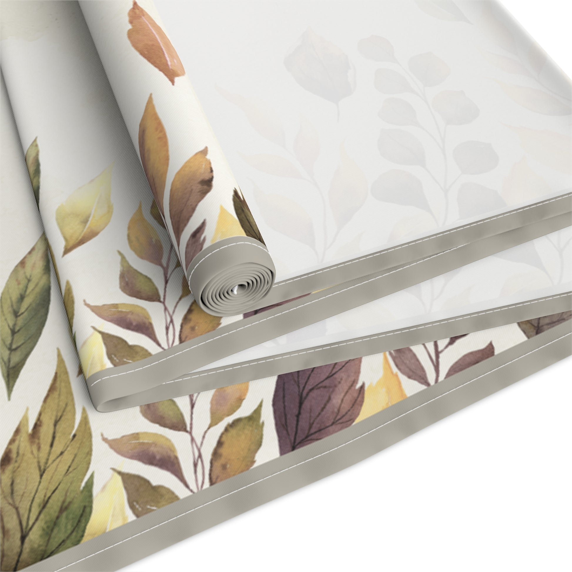 Roll of Fallen Leaves table runner with leaf pattern on a white background